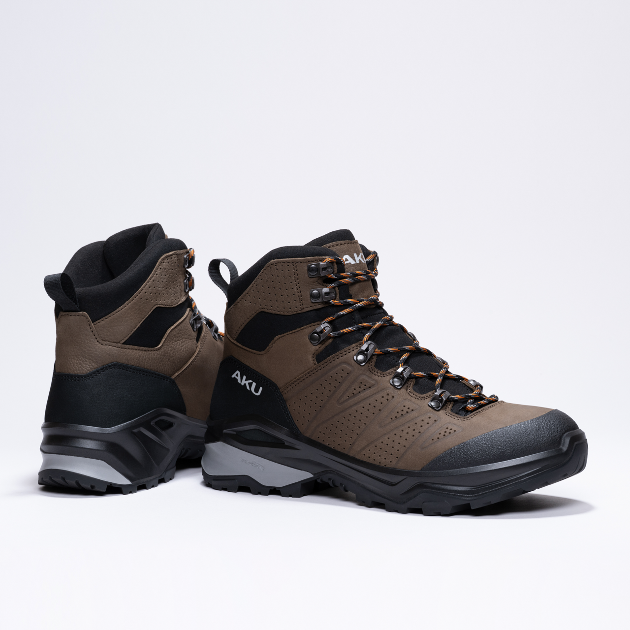 Brown and black rugged hiking boots with sturdy soles and secure lacing system.