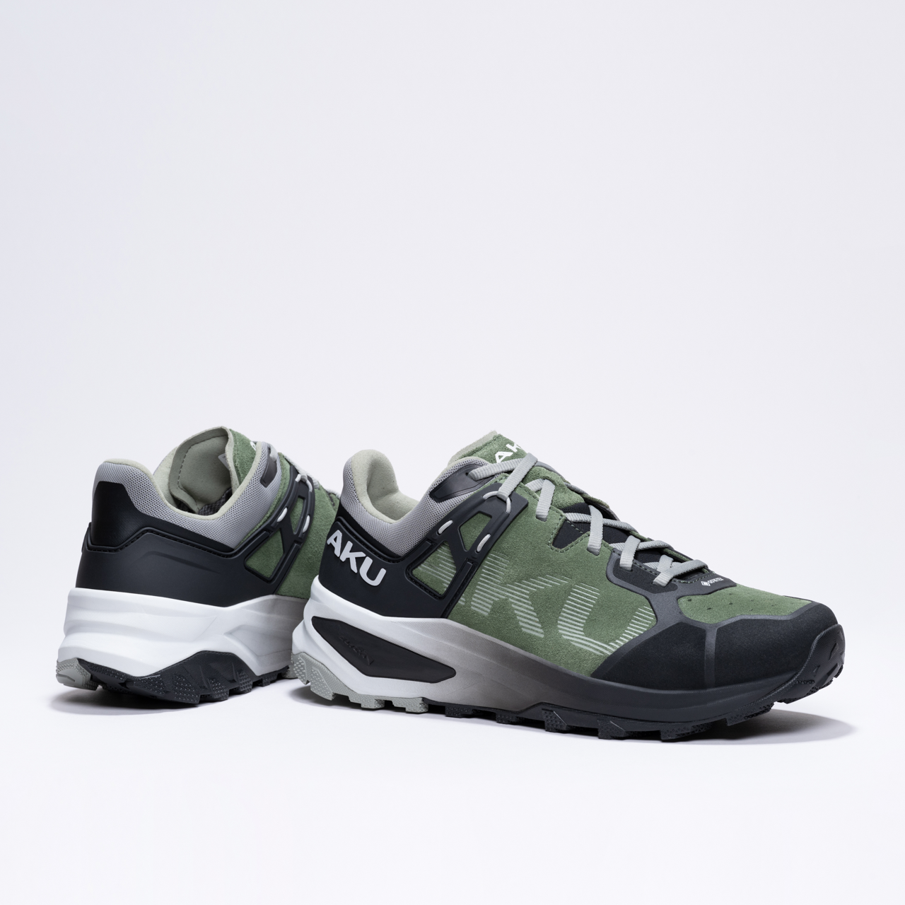 Dark green and black hiking shoes with gray accents and rugged soles, branded "AKU".